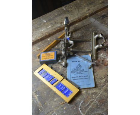 A 'RECORD' improved combination plane with spare blades and a boxed cutter clamping bracket