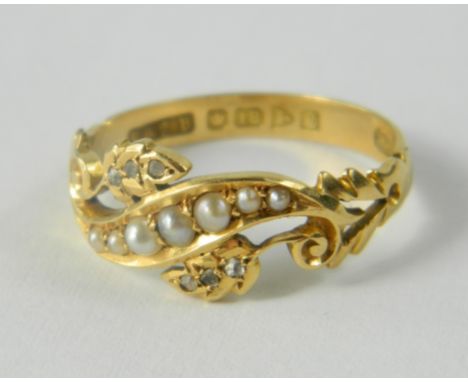 18ct Hallmarked ring set with 7 graduating half seed pearls in a wave design, and 3 small diamonds set in each leaf either si