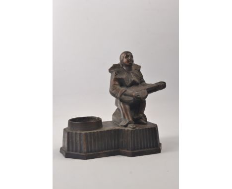 1930's Art Deco spelter lamp base in the form of a seated jester playing the guitar.