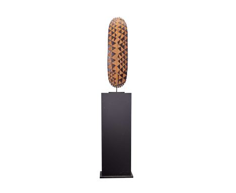 An East African Light Wood Harp, of slighly convex oblong form, carved and stained in black with chequered diapering, the cen