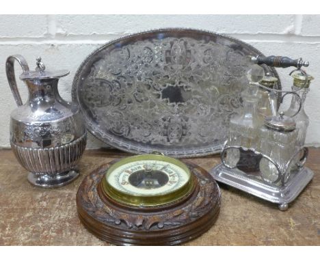 A plated tray, jug and a four bottle cruet and a carved aneroid barometer