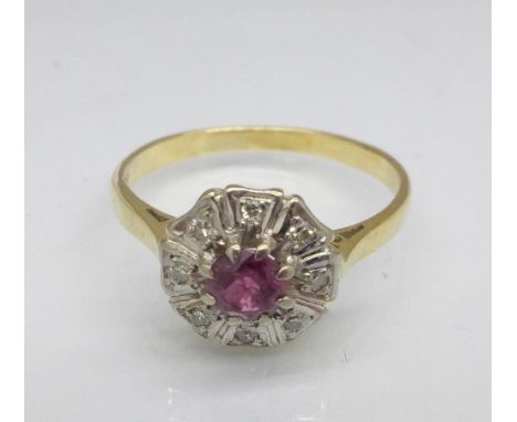 An 18ct gold, ruby and diamond cluster ring, 3g, N