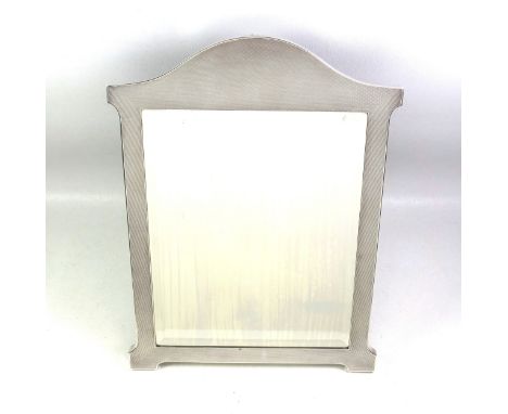 George V silver mounted dressing table mirror with a bevelled rectangular plate, oak easel back, and engine turned frame with