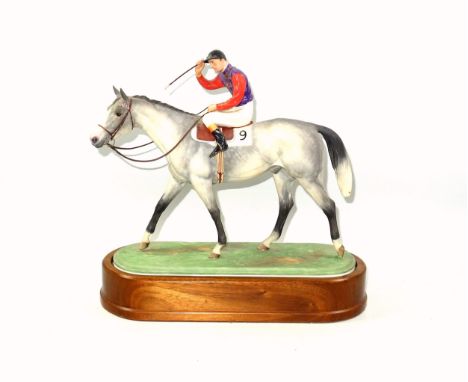 Royal Worcester model of a Jockey and horse, 'The Winner' by Doris Lindner, on wooden stand, black printed mark to underside,