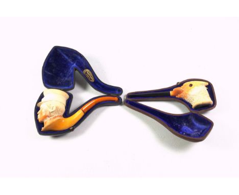 Meerschaum pipe, the bowl carved in the form of a Japanese military officer, with a detachable amber stem, (stem a/f), in a f