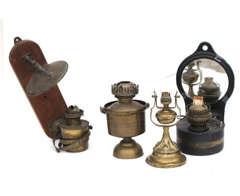 Two oil lamps on gimbal mounts together with another which has been converted to electric and a wall mounted oil lamp with mi