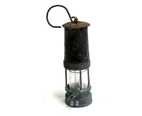A Miner's lamp, 25cms (9.75ins) high.