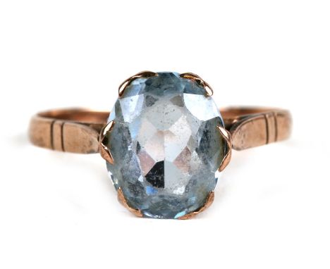 A 9ct gold dress ring set with an oval pale blue stone, approx UK size 'O'.