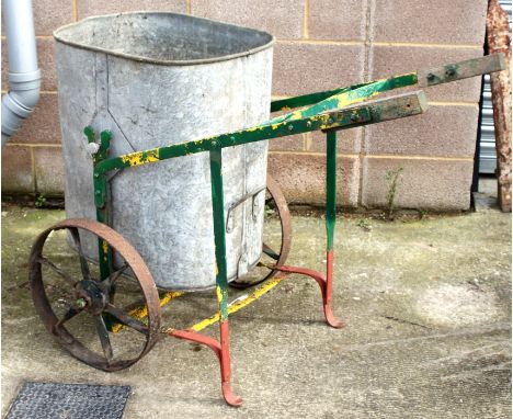 A galvanised metal water bowser.