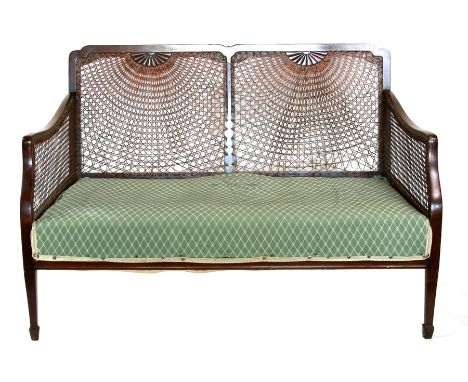 A bergere two-seater sofa with single caned sides and back, 114cms (45ins) wide.