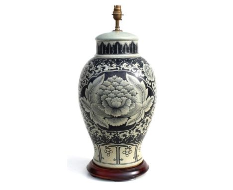 A large pottery table lamp of baluster form decorated with flowers, 50cms (20ins) high.