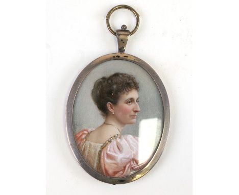 An Edwardian oval portrait miniature depicting a young lady wearing a pink dress, 5 by 6cms (2 by 2.25ins).Condition Reportap