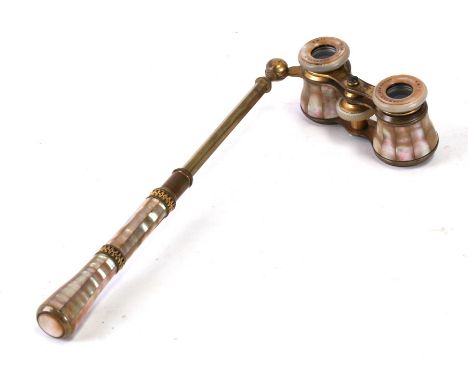 A pair of brass and mother of pearl opera glasses with extending handle, marked 'Schwalb Hermanos of Lima, Peru'.Condition Re