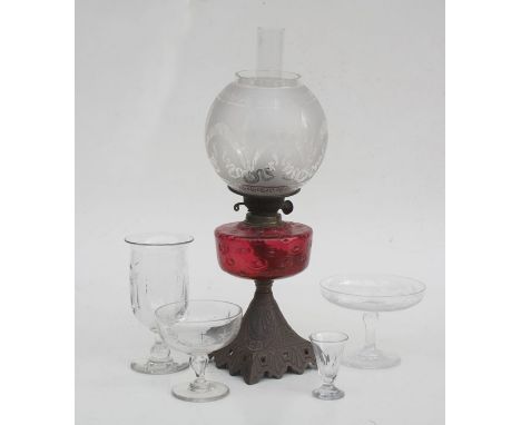 An oil lamp with cranberry glass reservoir and acid etched shade, 56cms (22ins) high; together with a celery vase and other g