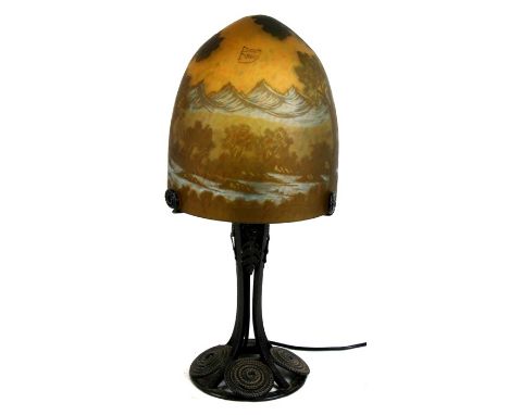 An early 20th Century Secessionist table lamp having hand worked metal base with Daum Nancy style domed glass shade.53cm (21 