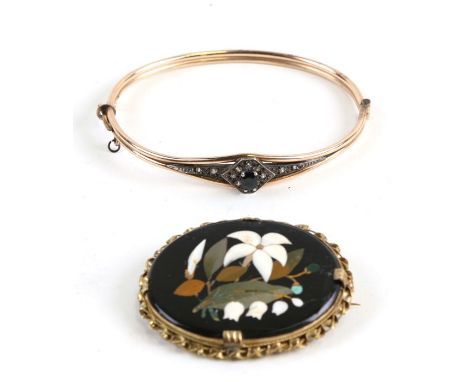 A 19th century pietra dura oval brooch; together with a sapphire and white stone set yellow metal bangle (2).