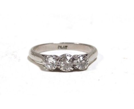 A platinum and three-stone diamond ring, approx UK size ‘M’. 