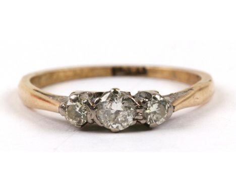 An 18ct gold three-stone diamond ring, approx UK size 'K'.Condition Reporthallmarked, shank worn a little, no chips to stones