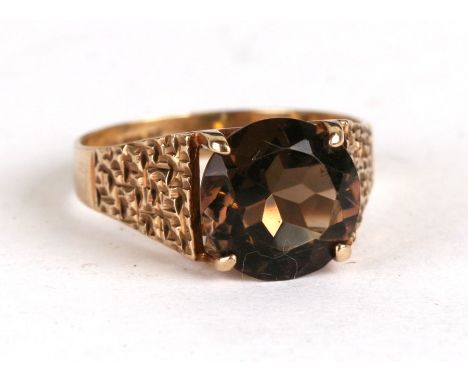 A 9ct gold and smoky quartz dress ring, approx UK size 'O'.Condition Reporthallmarked, stone has a couple of very small scrat