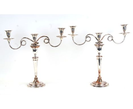 A large pair of George III Old Sheffield Plate three-arm candelabra, 49cms (19.25ins) high.Condition Reportboth columns have 