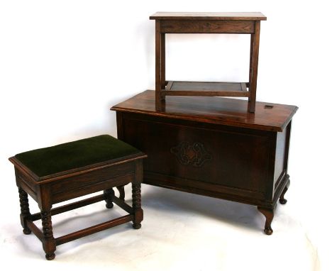 An oak stool with upholstered lift-up lid, on bobbin turned supports, 56cms (22ins) wide; together with an oak blanket box, 9