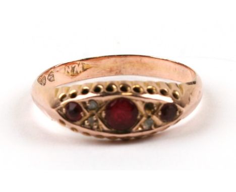 A 9ct gold ring set with three rubies and four clear stones, approx UK size 'P'.Condition ReportOne of the clear stones missi