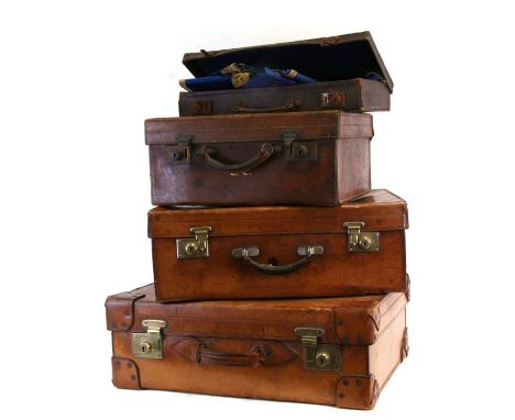 Three vintage leather suitcases, the largest 60cms (24ins) wide; together with a suitcase containing Masons Regalia.Condition