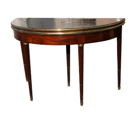 A 19th century mahogany demi-lune card table with brass mounts, on reeded tapering legs, 115cms (45.5ins) wide.