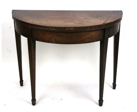 A 19th century mahogany demi-lune card table on square tapering legs with spade feet, 91cms (35.75ins) wide.