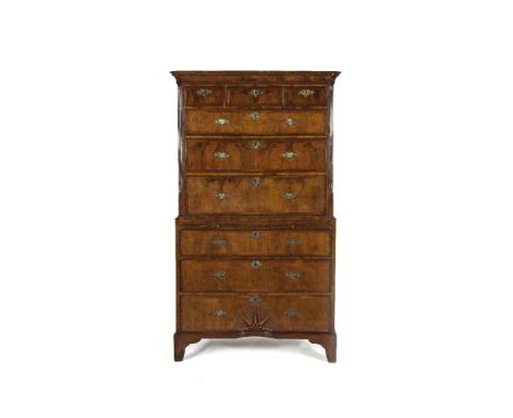 A GEORGE II WALNUT TALLBOY CHEST, with moulded cavetto cornice, above three short and three long graduated, cross and feather
