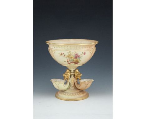 A ROYAL WORCESTER BLUSH PORCELAIN CIRCULAR FLOWER BOWL, the shaped circular bowl with three panels of flower sprays on a pede