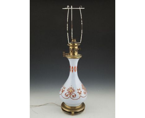 A 19TH CENTURY PALE BLUE AND RED ARABESQUE DECORATED CIRCULAR BALUSTER VASE OIL TABLE LAMP, with gilt highlights and raised o