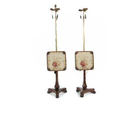 A PAIR OF REGENCY ROSEWOOD FRAMED POLE SCREENS, c.1820, converted to standard lamps, each with adjustable tapestry panel, on 