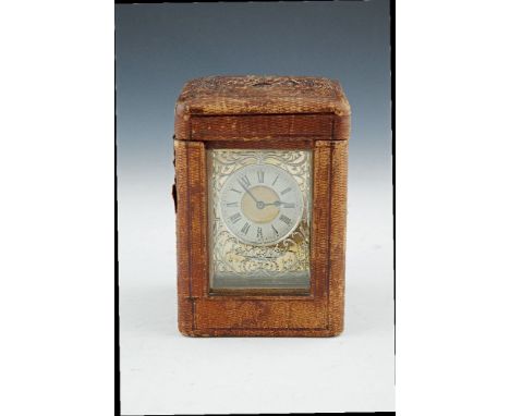 A 19TH CENTURY BRASS CASED TRAVELLING MANTLE CLOCK, of rectangular form, 16cm to handle, surmounted with swing handle above a