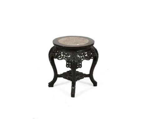 A CHINESE CARVED CHERRYWOOD AND ROUGE MARBLE JARDINIÈRE STAND, c. 1900, the circular top over pierced frieze panels on short 