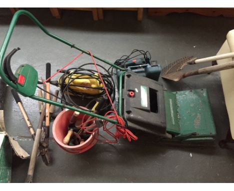 A quantity of garden equipment including rakes, a Kercher pressure washer, loppers, forks, a Qualcast mower and a Black and D
