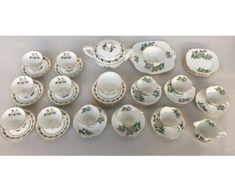 A part tea set of fine bone china to include a teapot, milk jug, sugar bowl, cups, saucers and a sandwich plate from various 