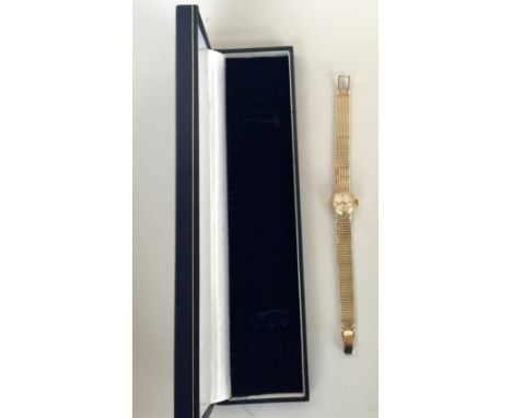 Ladies gold Omega watch with hallmarked 9ct gold integral woven strap, round champagne dial with raised batons, hand dial pai
