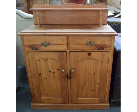 A pine dresser/cupboard with plate stand over two short drawers over a cupboard with double doors and internal shelf 97cmW