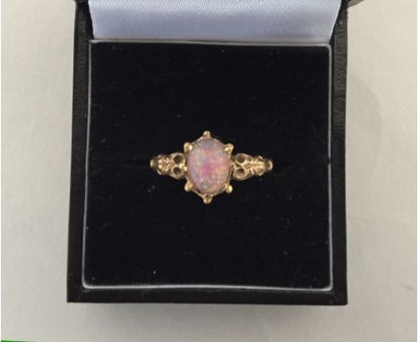 A delicate gold ring with opal stone of pink, gold and blue hue, hallmark unreadable 