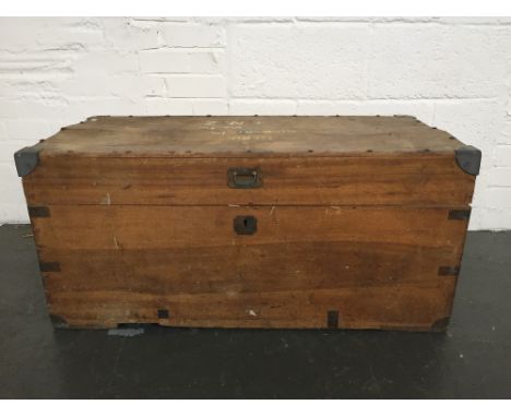 A vintage wooden trunk with metal handles and reinforced metal corners, inside tray, bearing various labels such as the New Z