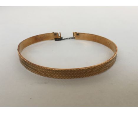 A 9ct gold bangle with bright cut decoration by Maylin Products Ltd, London 0.35oz t 