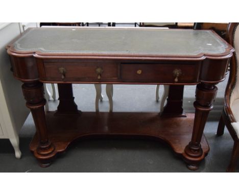 A mahogany sideboard with green skiver heightened in gilt over two short drawers with brass drop handles, raised on fluted tu