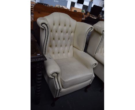 Two button back cream leather wingback armchairs on cabriole legs (2)