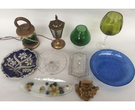 A selection of glassware including a green glass lamp with wooden frame