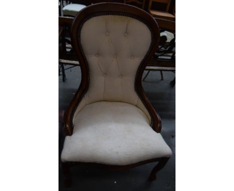 A cream upholstered balloon back button back bedroom chair raised on cabriole legs 