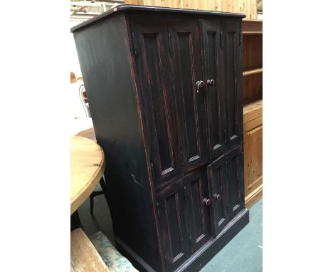 A cupboard with double hinged doors and internal pull out shelf over another cupboard with double doors 81cmW