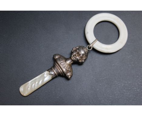 A HALLMARKED SILVER BABY'S TEETHER IN THE FORM OF A CHILD - BIRMINGHAM 1934, with mother of pearl handle and later replacemen