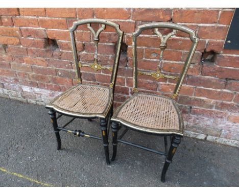 A PAIR OF VICTORIAN EBONISED BERGERE CHAIRS, with inlaid mother of pearl decoration