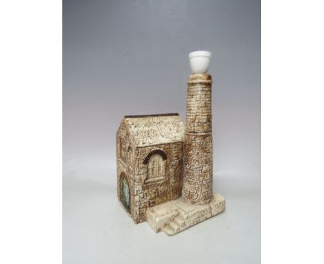 A TROIKA POTTERY LAMP BASE IN THE FORM OF A FACTORY, modelled in low relief with typical decoration, by Jane Fitzgerald, pain